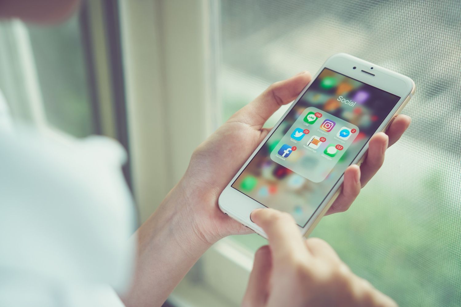 Woman holding Android phone with RCS app