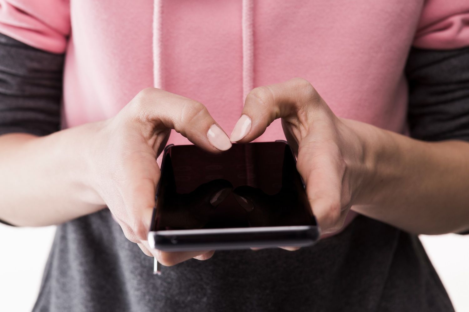 woman holding a phone with dark screen