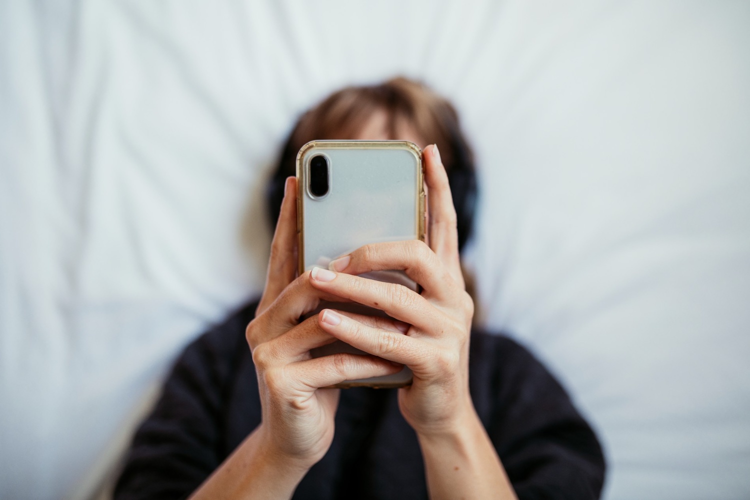 woman texting with screen not visible