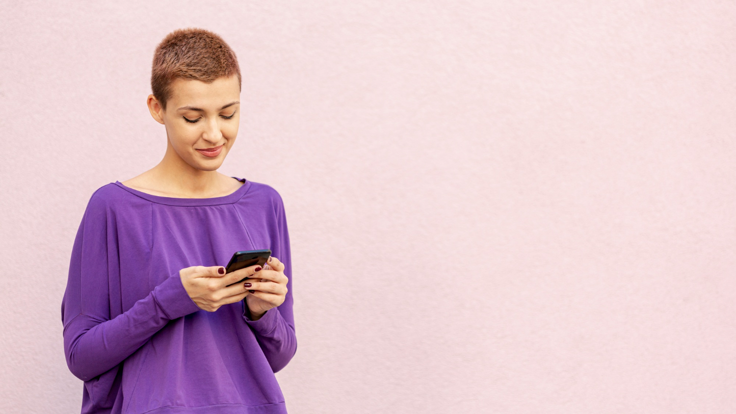 woman looking at her phone happily woman looking at her phone happily